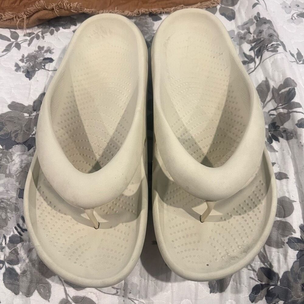 Crocs Mellow Flip sandals feature a thick, comfortable footbed designed for reco